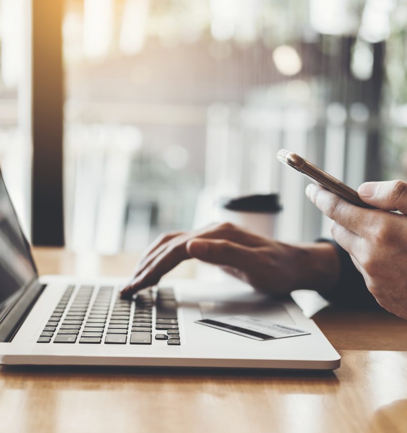 Online banking businessman using Laptop with credit card Shopping online Fintech and Blockchain concept