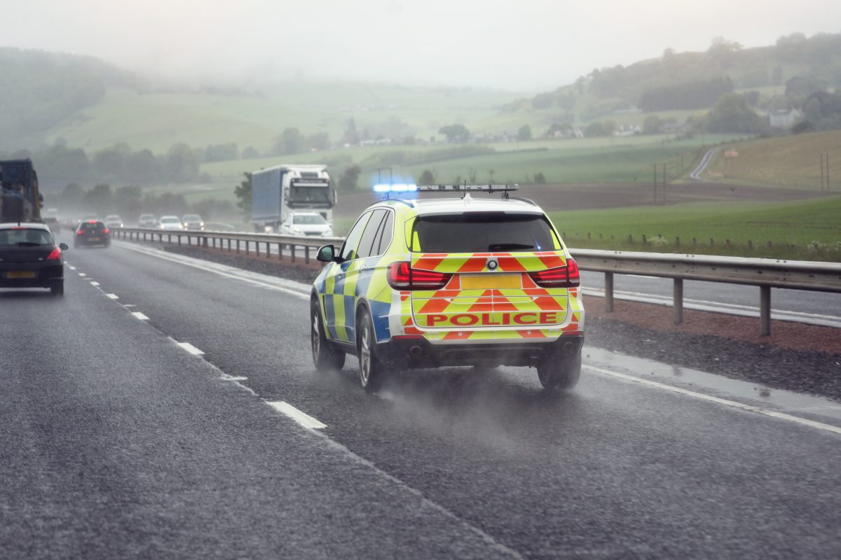 Police siren flashing blue lights driving on motorway to accident or crime scene
