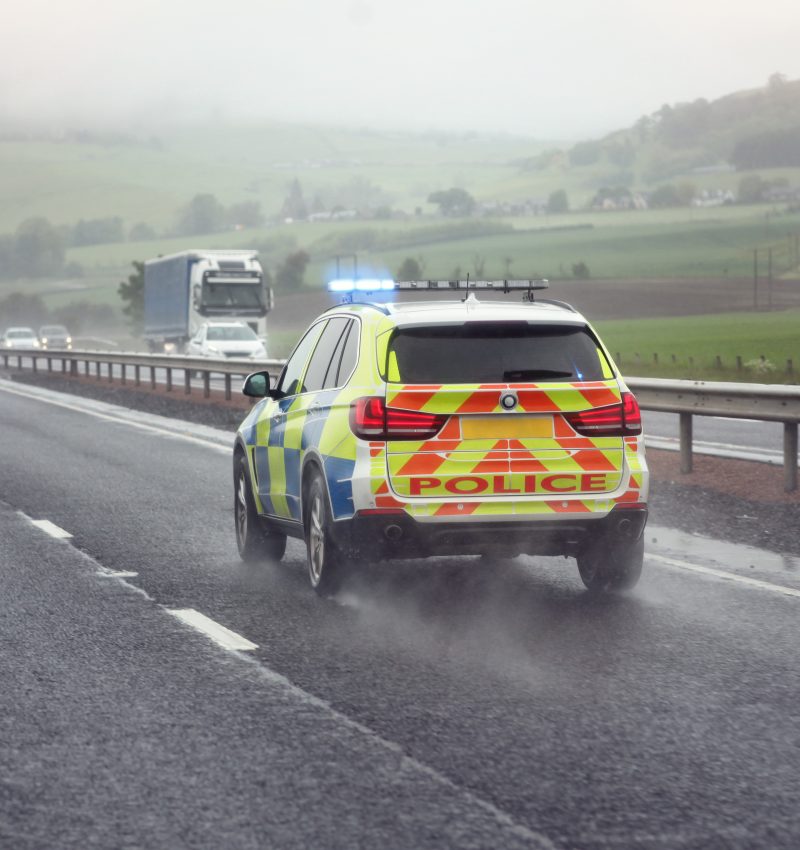 Police siren flashing blue lights driving on motorway to accident or crime scene