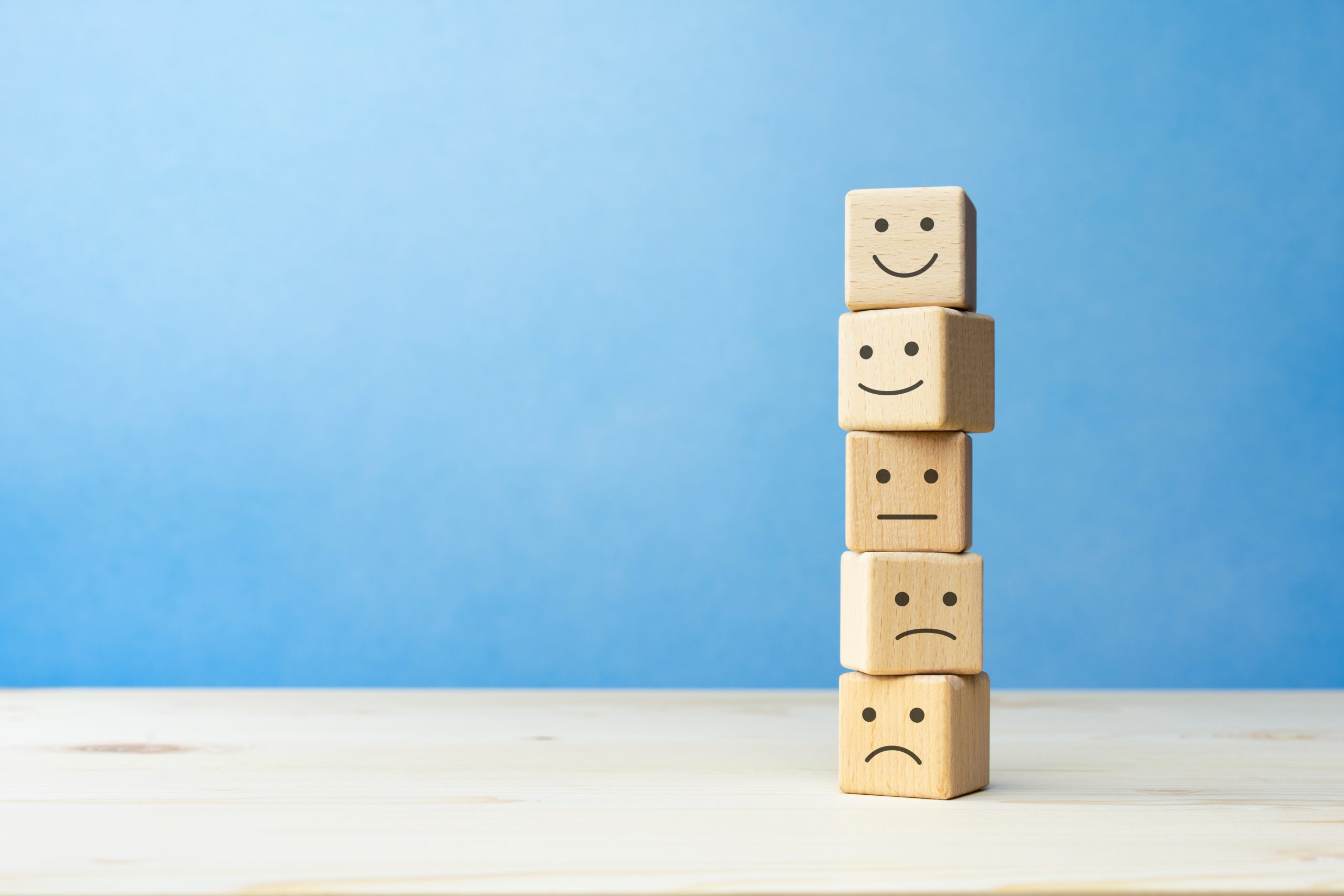 Wooden blocks with the happy face smile face symbol symbol on the table, evaluation, Increase rating, Customer experience, satisfaction and best excellent services rating concept with copy space