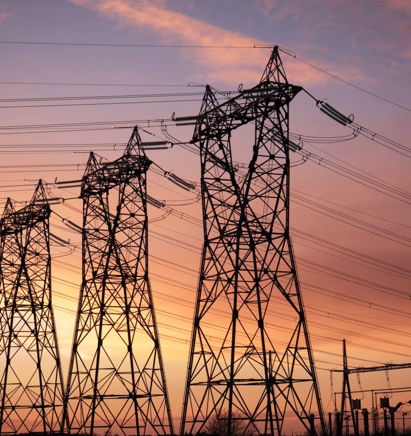 high voltage pylons silhouette cloudy sky background