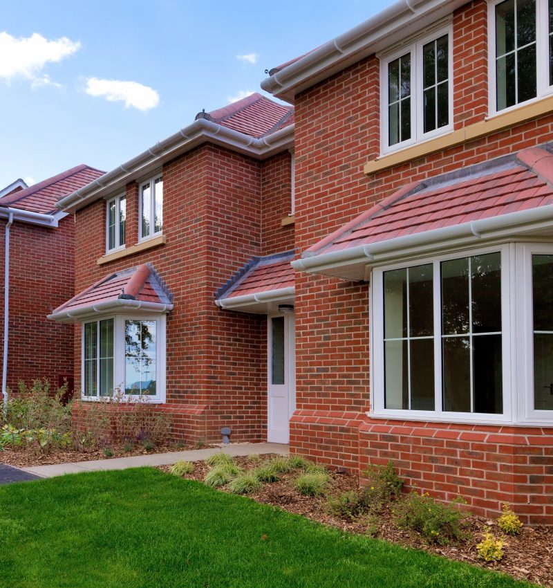 Photo of a row of brand new empty houses for sale on a housing development.